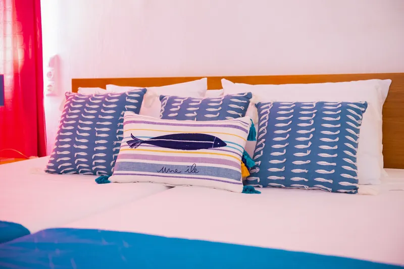 Cuscini con motivo a pesce sul letto