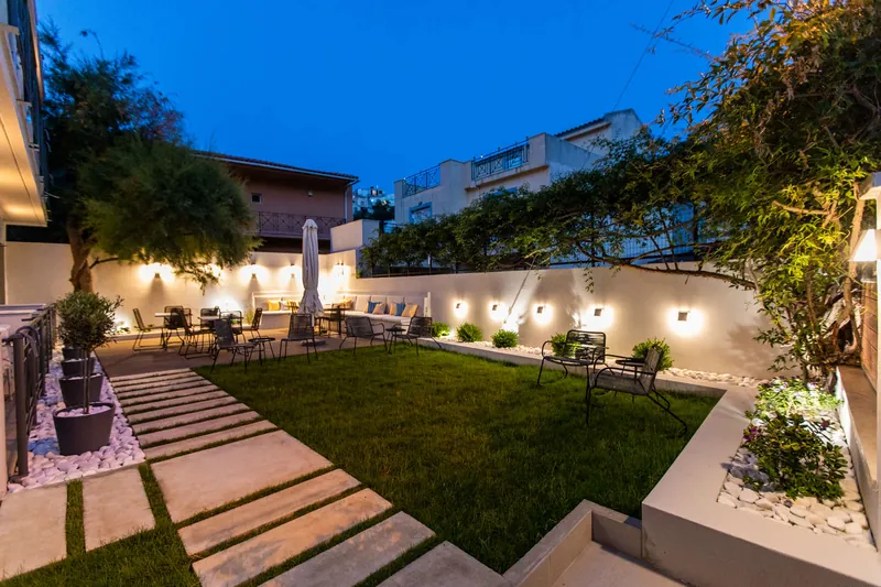 The garden at dusk, with its lights on