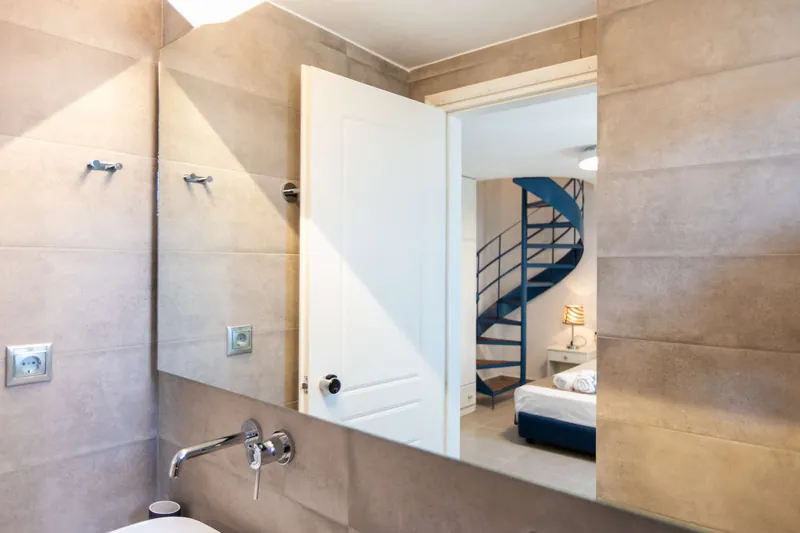 The maisonette bathroom, with the spiral stairs beyond
