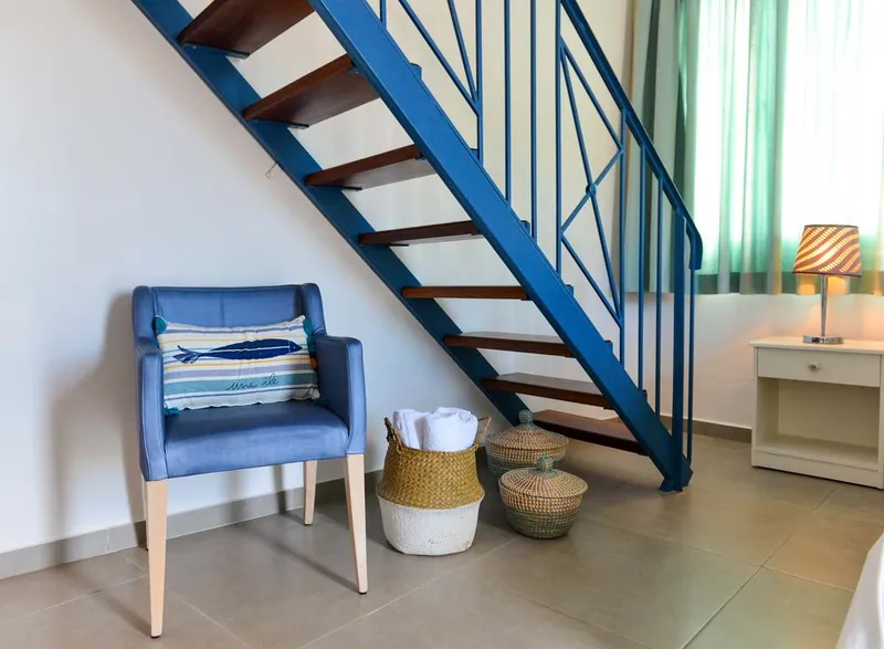 The maisonette’s blue staircase and armchair