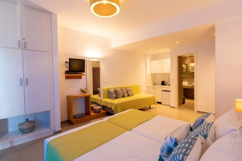 A Superior Studio with a yellow sofa and kitchenette