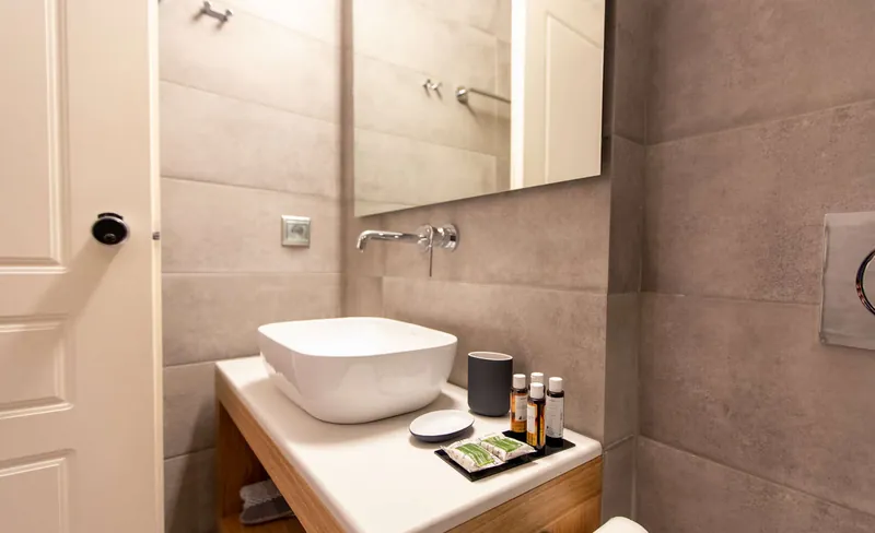 A white basin on a concrete-look counter